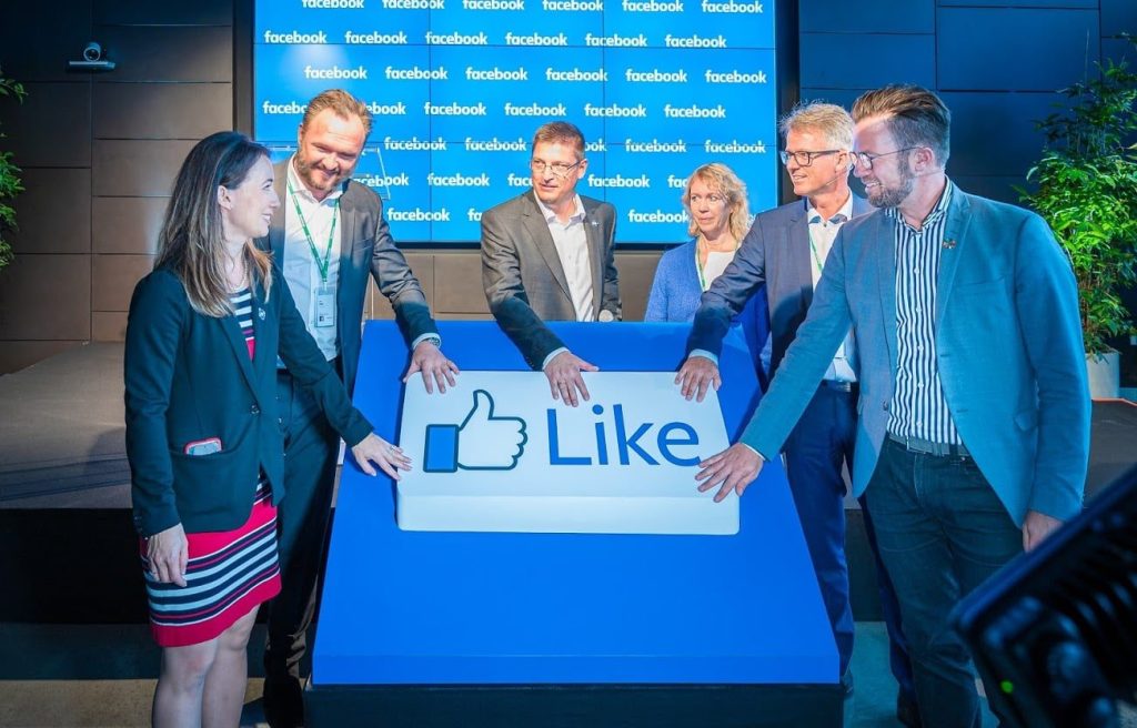 Photo of group of people touching a like reaction button