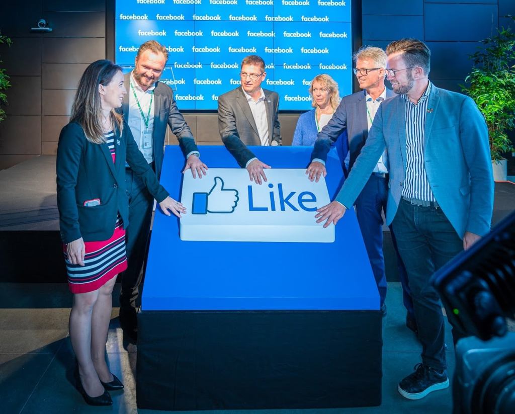 Photo of group of people touching a like reaction button