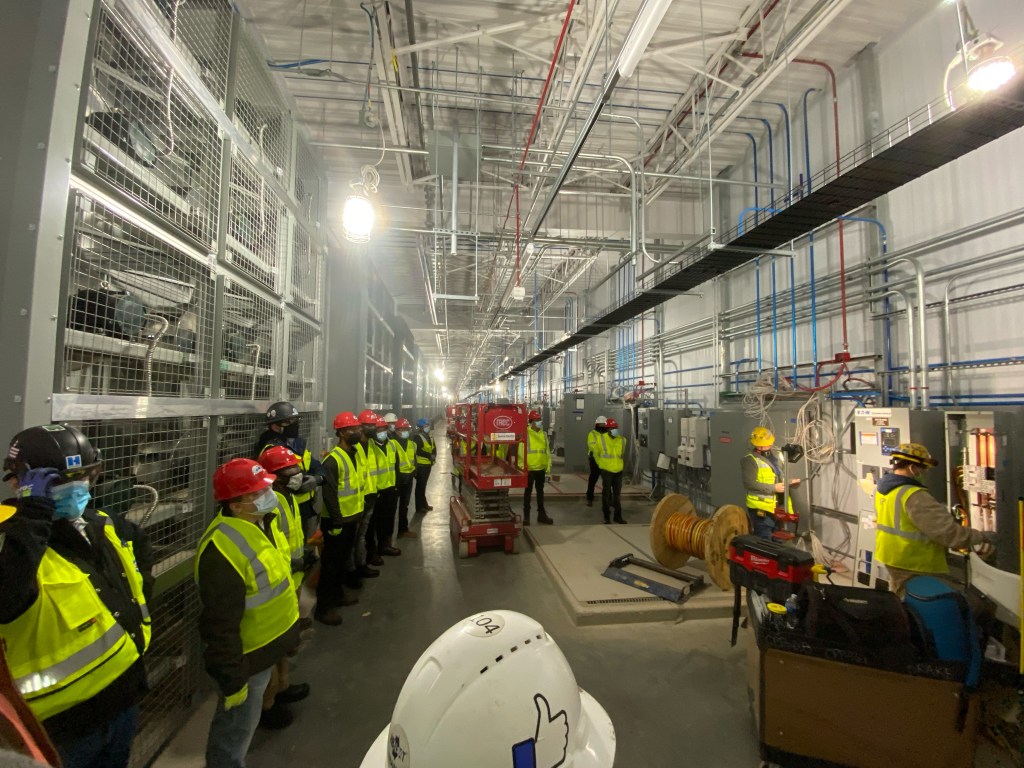 Construction workers touring in a data center