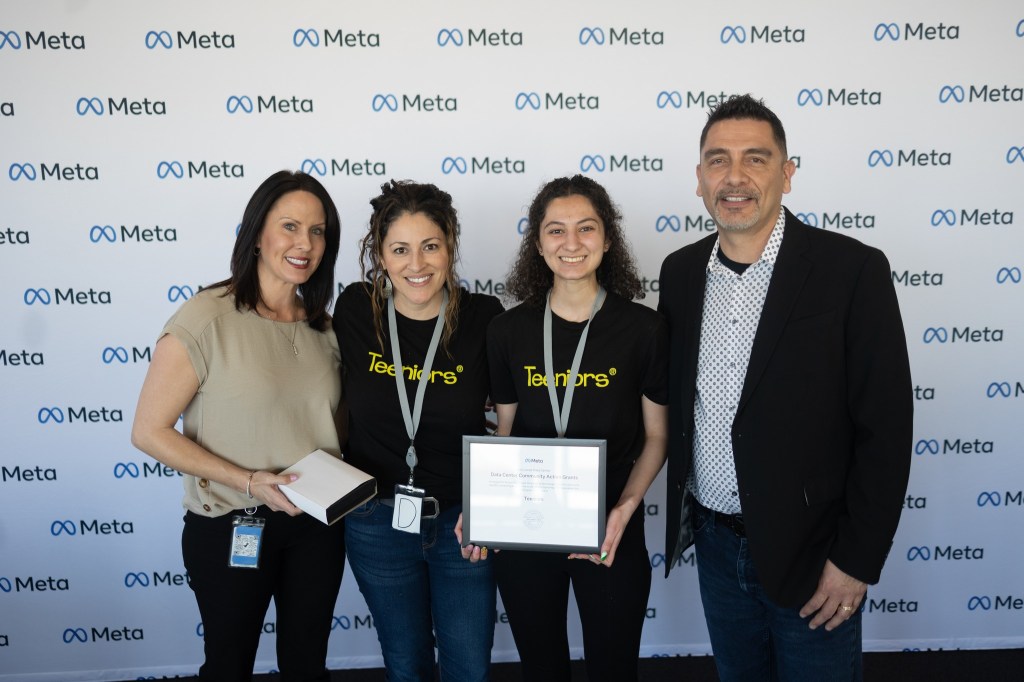 Three women and one man holding Data Center Community Action Grants awards