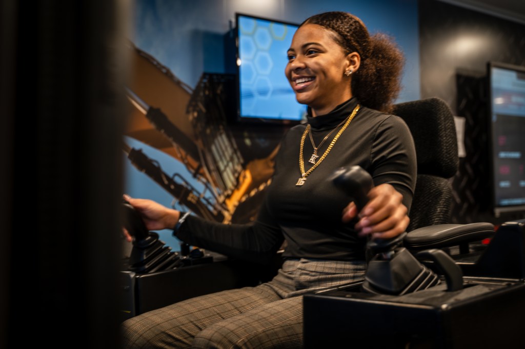 A young girl playing with a device