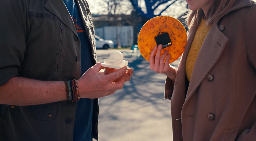 Two people holding a plastic material