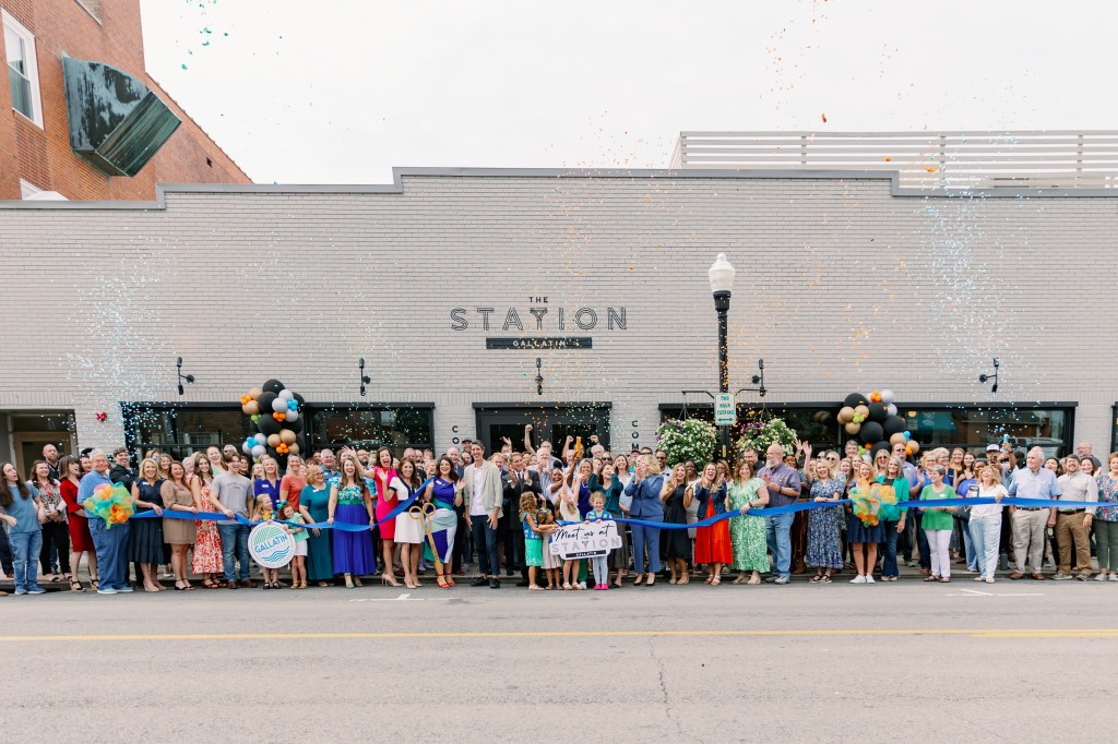 A community group celebrating The Station's ribbon cutting in Gallatin.