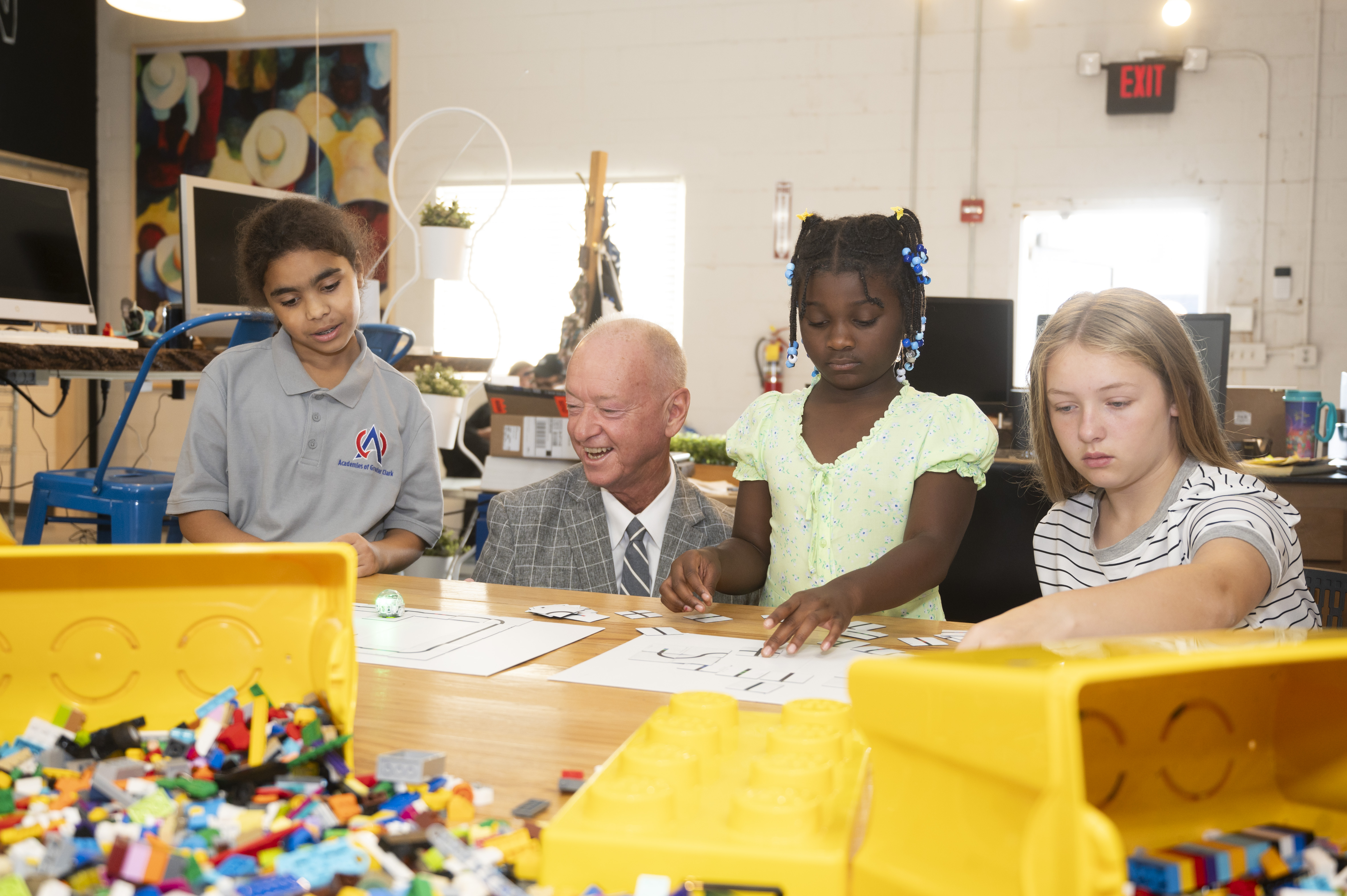 A group of kids working on STEAM and an adult
