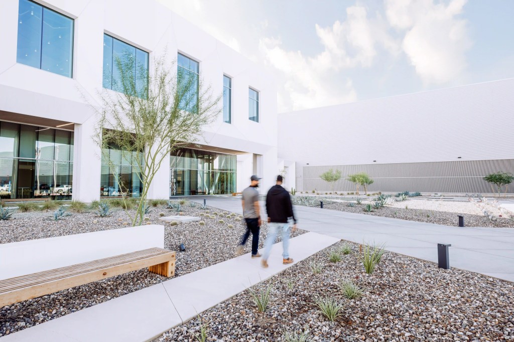 Two people walking outside of a Meta Data Center