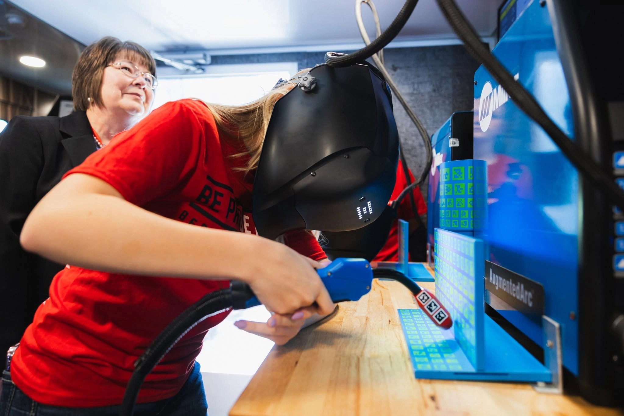 A girl learning to weld