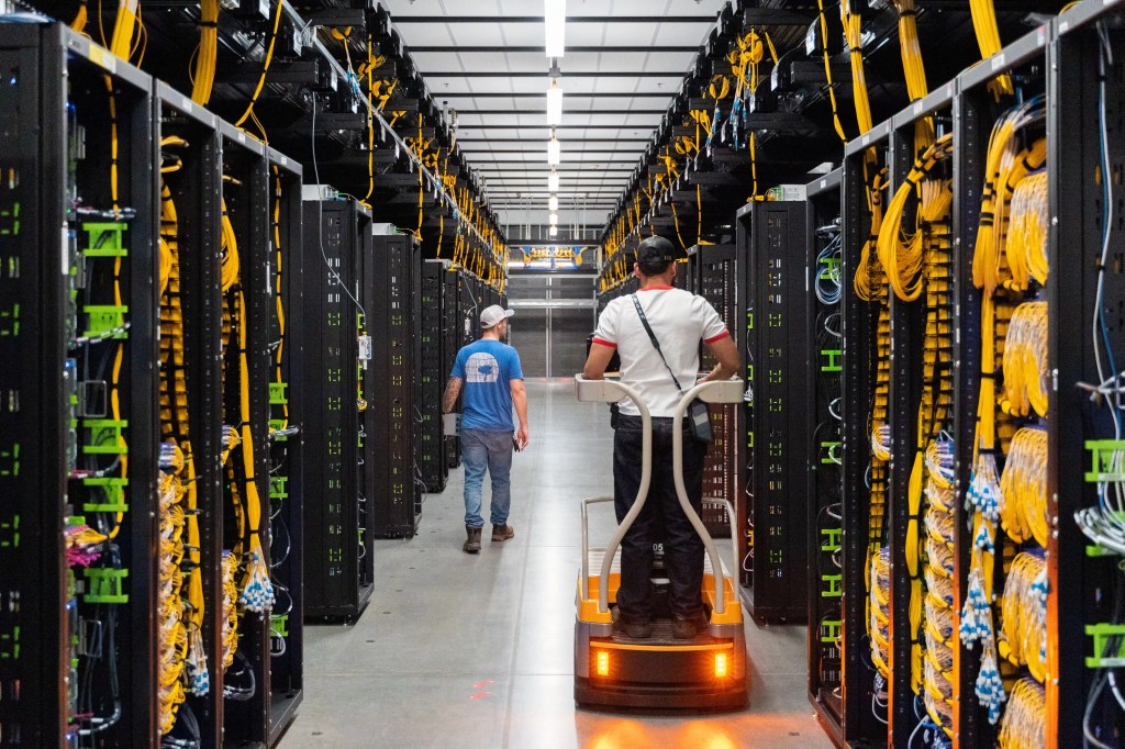Two employees at a data hall