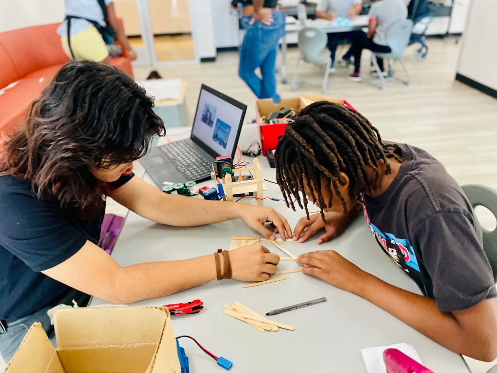 A group of kids learning with STEAM utensils